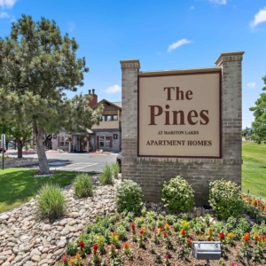 The Pines at Marston Lake Main Signage with leasing office in the background