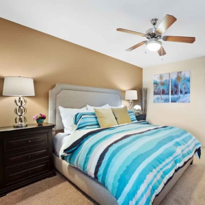 Bedroom of model home at Pines at Marston with ceiling fan and modern furnishings